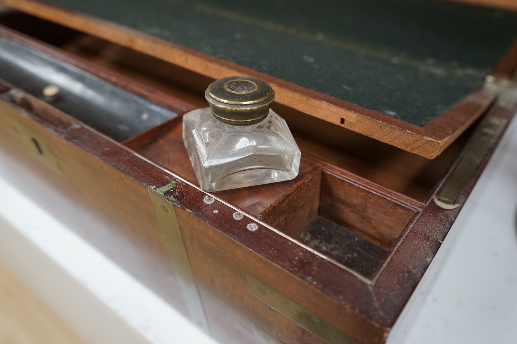 An early 19th century brass bound mahogany writing slope with maker's label for J. Allen, 45cm wide